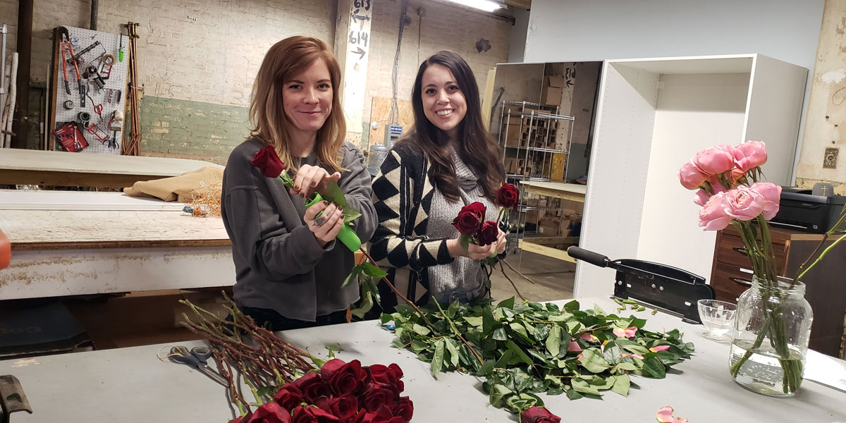 Floral design students with red rose