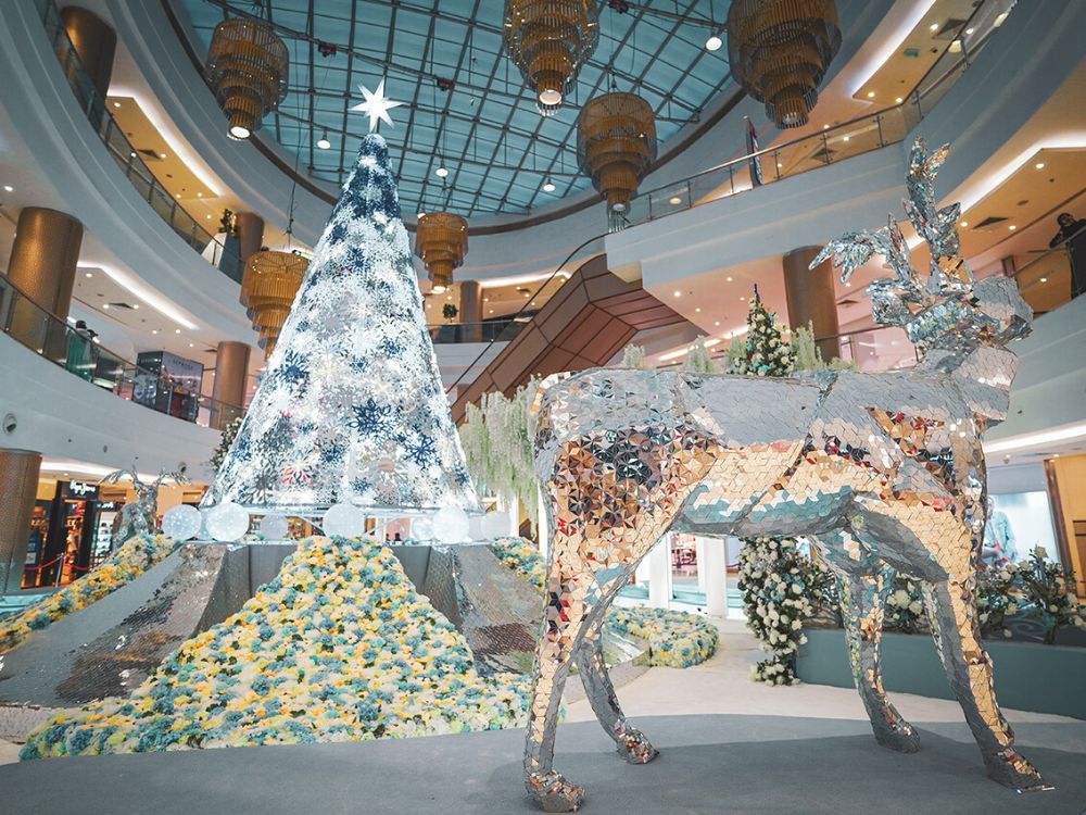 A Deer and a Christmas Tree in a Shopping Mall With a Floral Installation by Tomas de Bruyne on Thursd