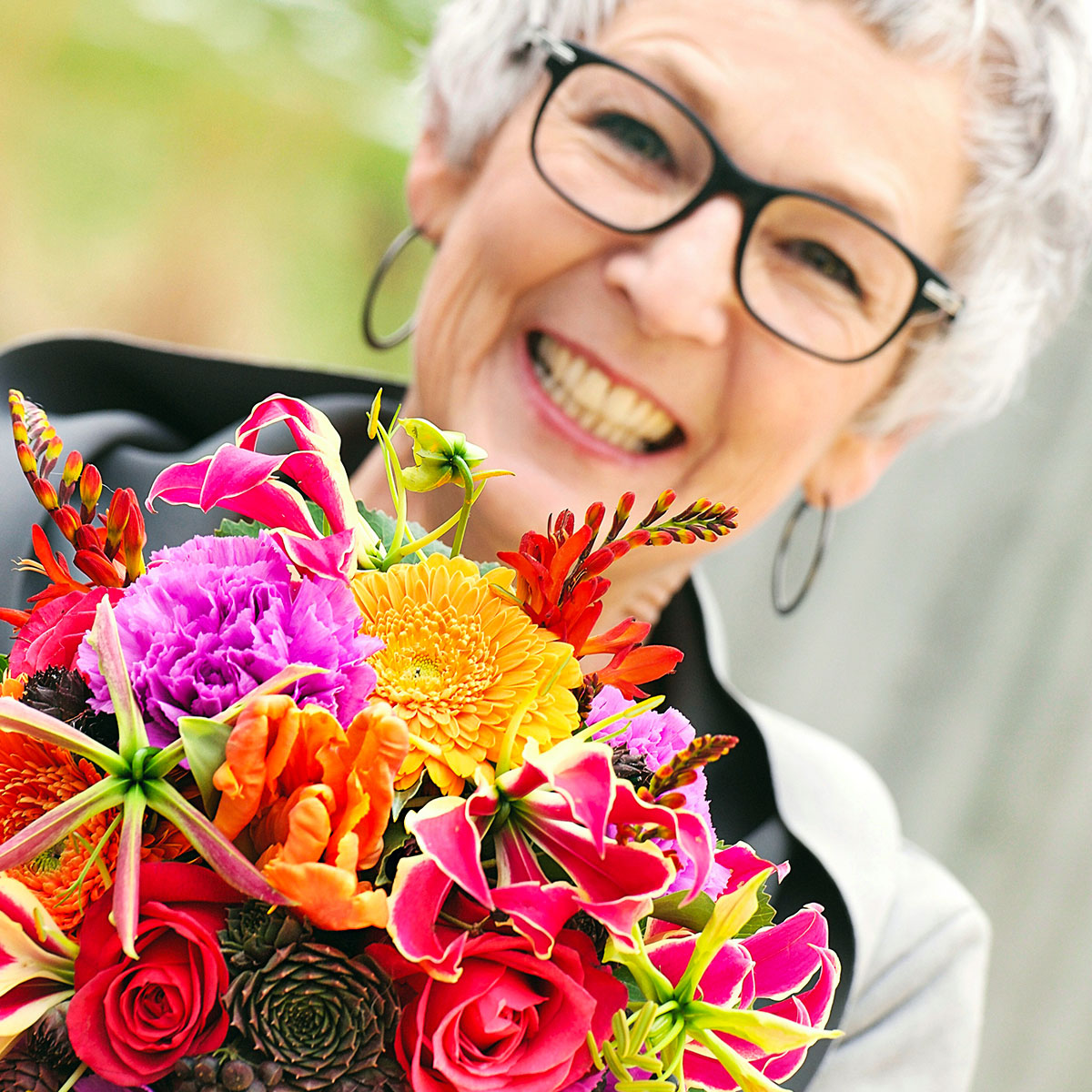 Old lady with gloriosa bouquet