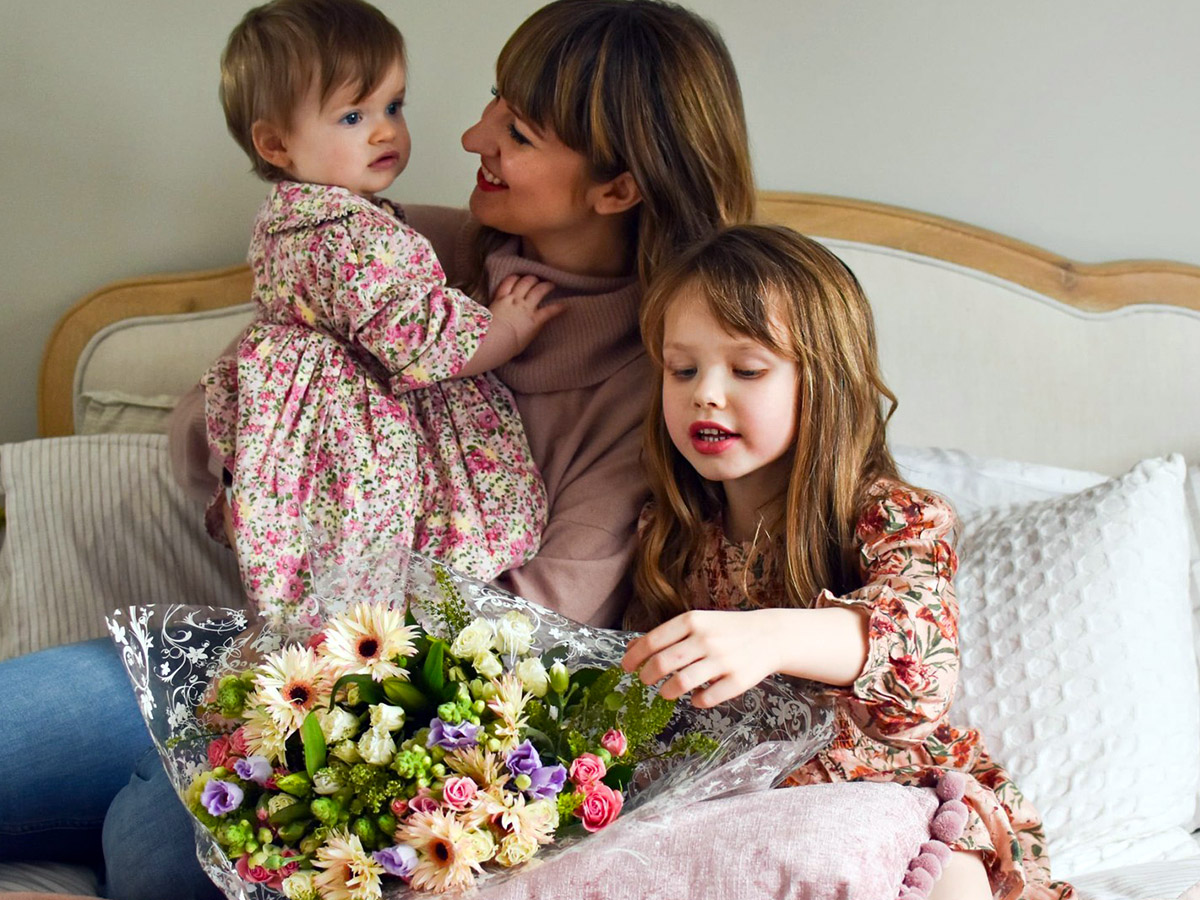 Mother with kids and bouquet