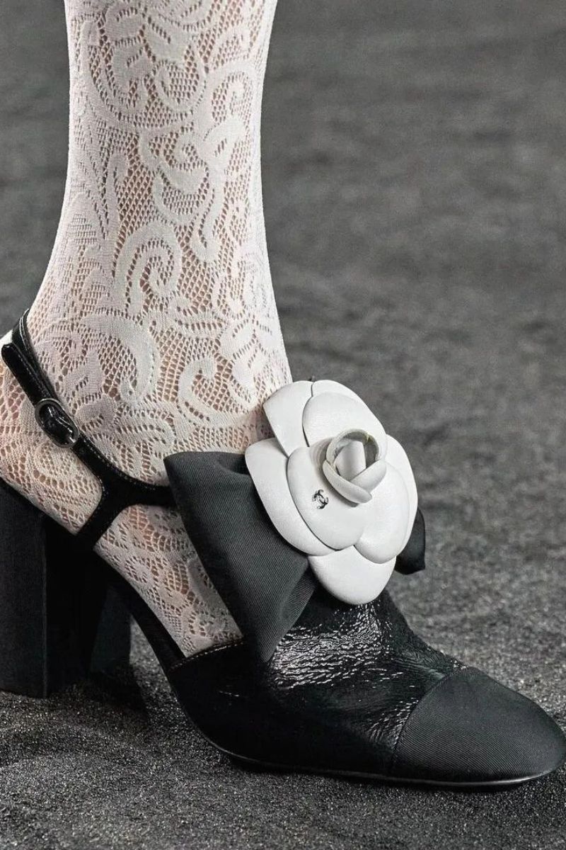 White camellia on black shoe Chanel