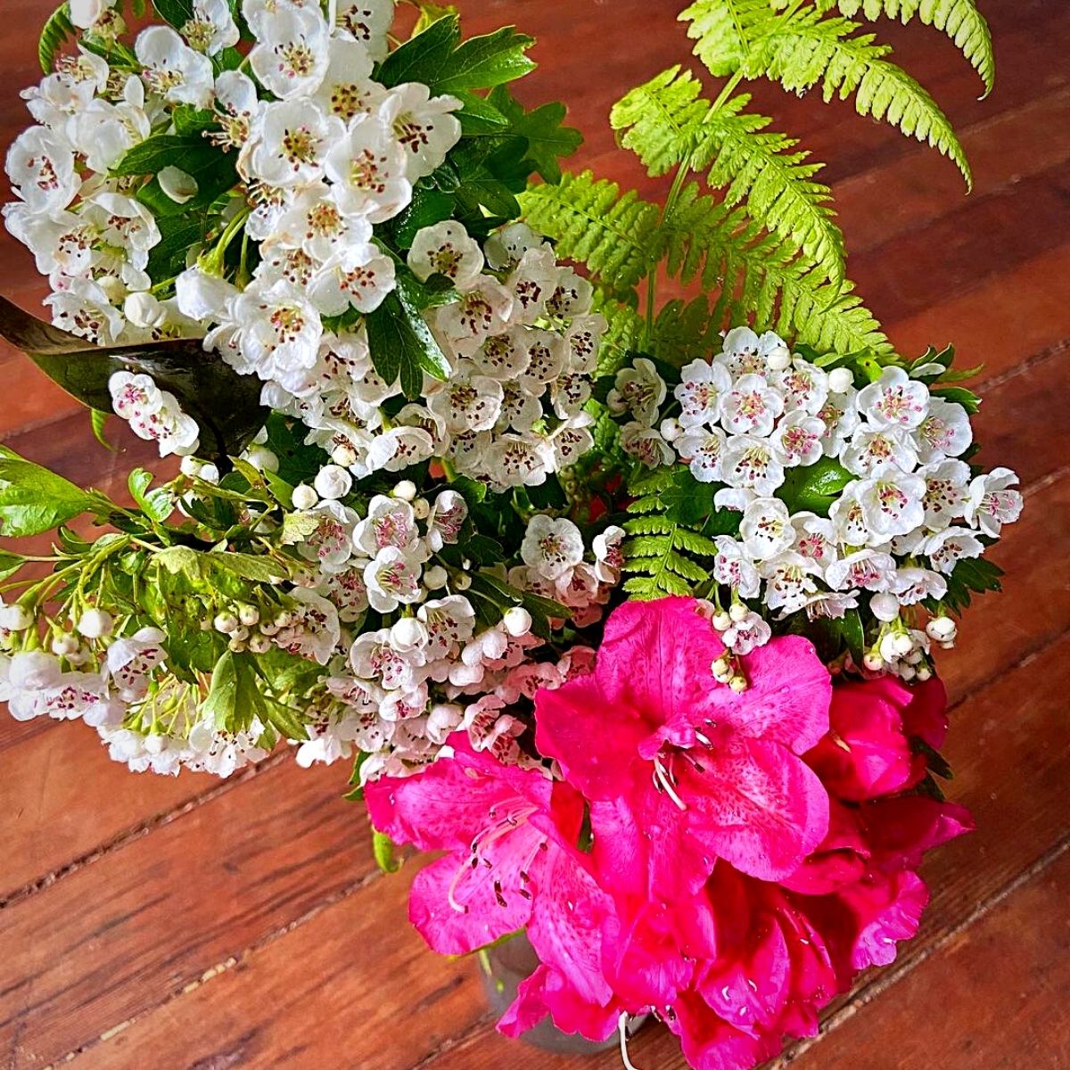 hawthorns and other flowers in a vase