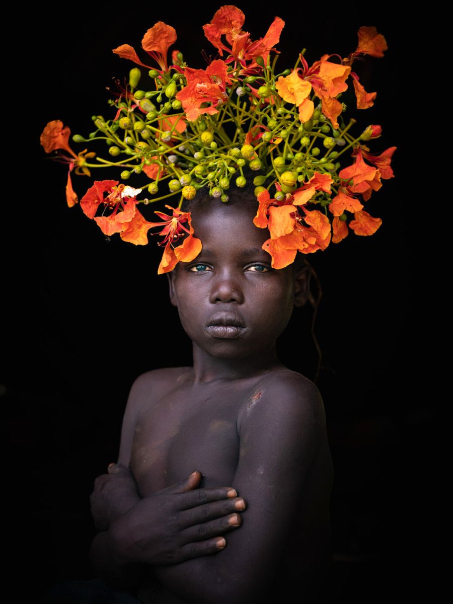 Mursi women adorn their heads with flowers