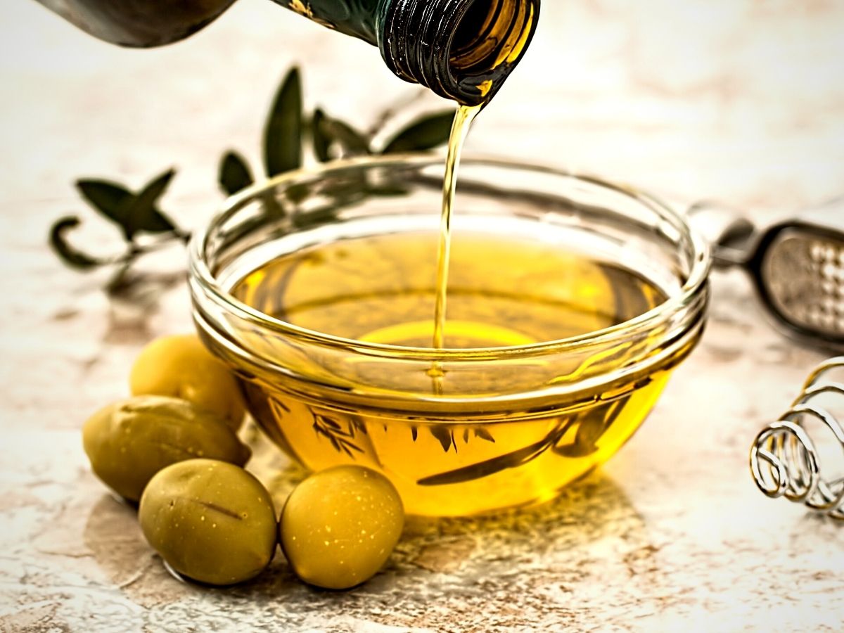 National Olive Day's Olive oil poured in a glass bowl