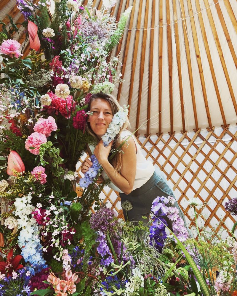 Lucinda Maria holding flowers in Yurt