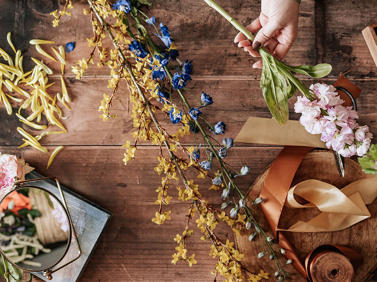 Florist with yellow blue and pink flowers