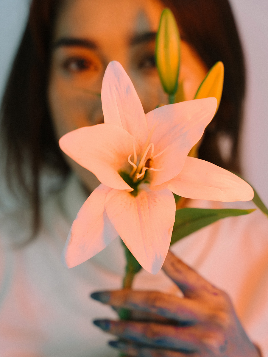 Muslim woman with white lily