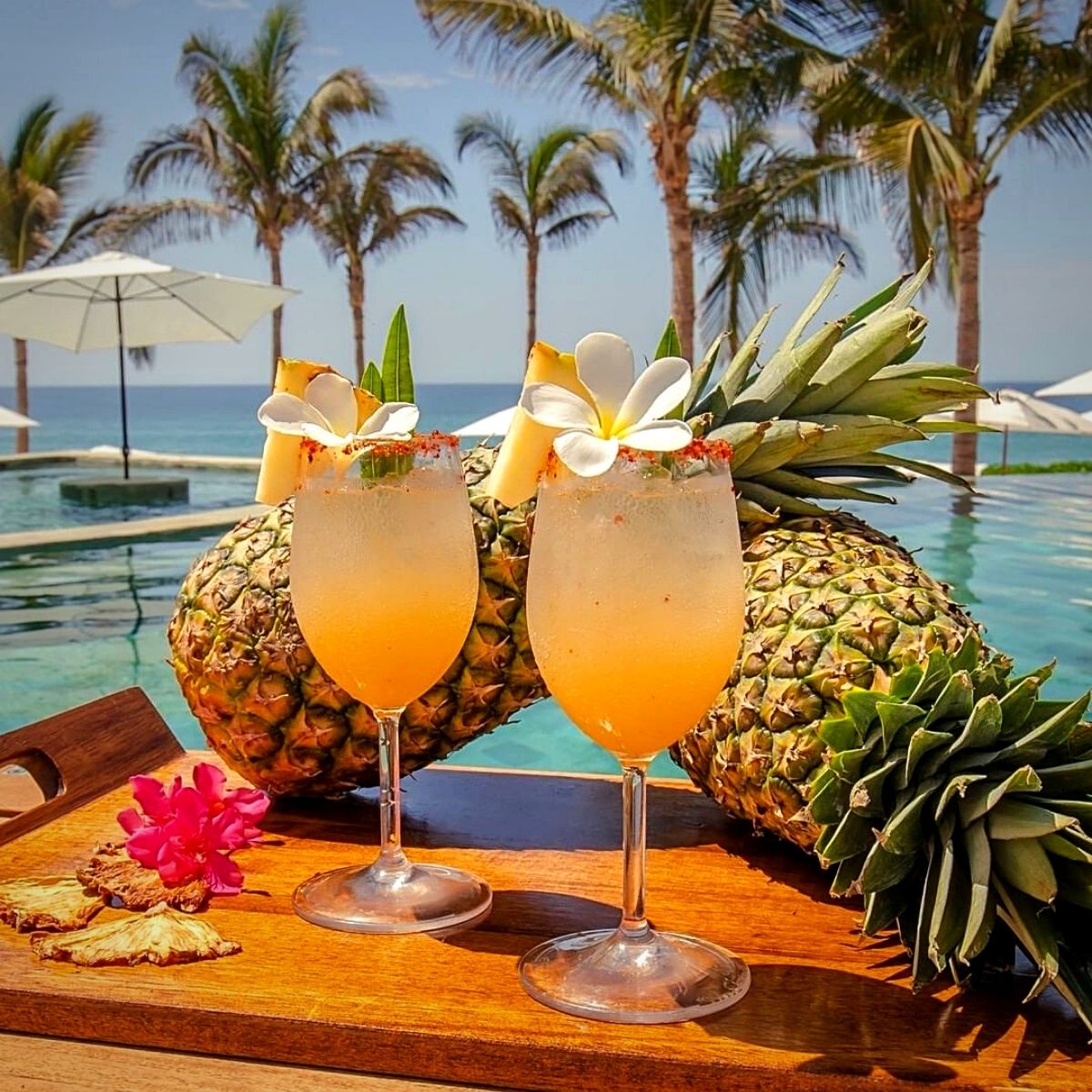 Pineapples on a poolside setting for International Pineapple Day