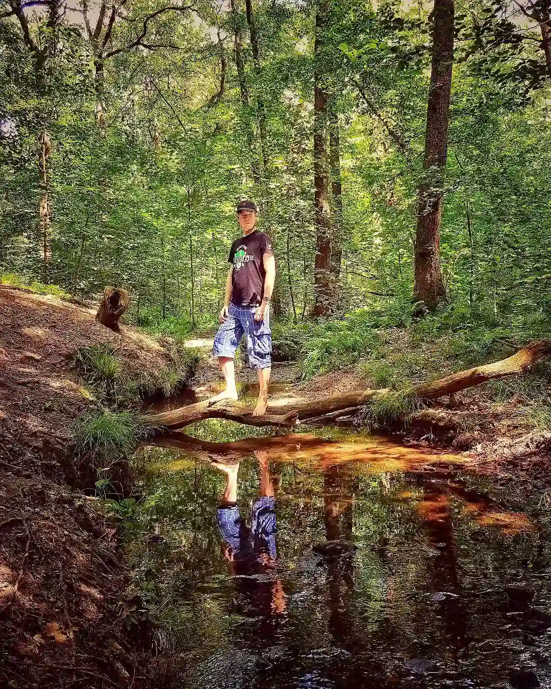 Man walking barefoot in forest for grounding benefits