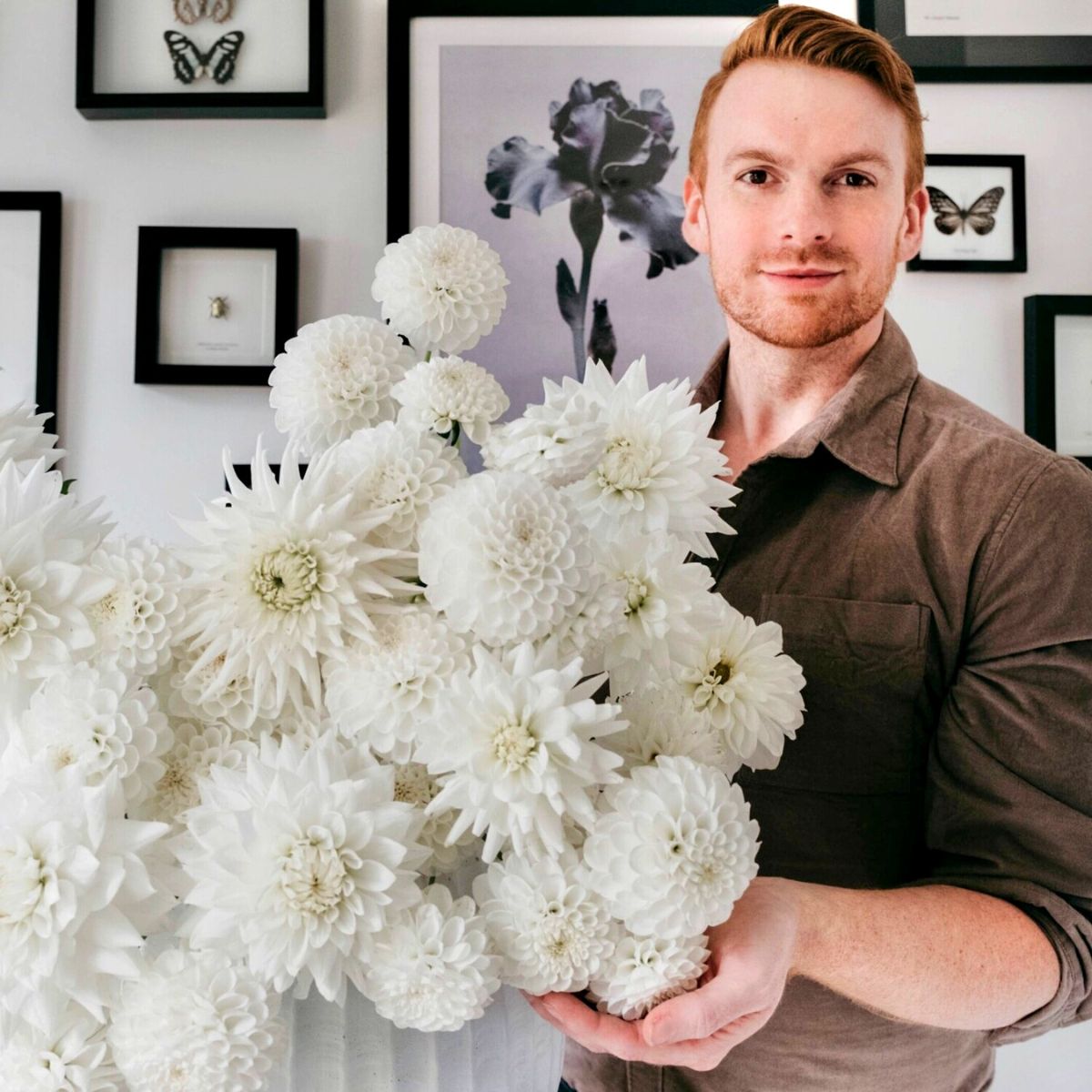 Joseph Massie smiling with white flowers