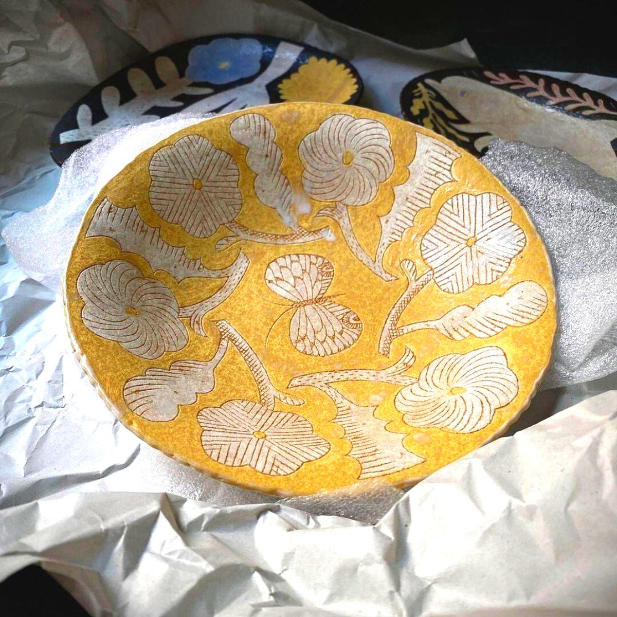 Yellow ceramic piece with flowers