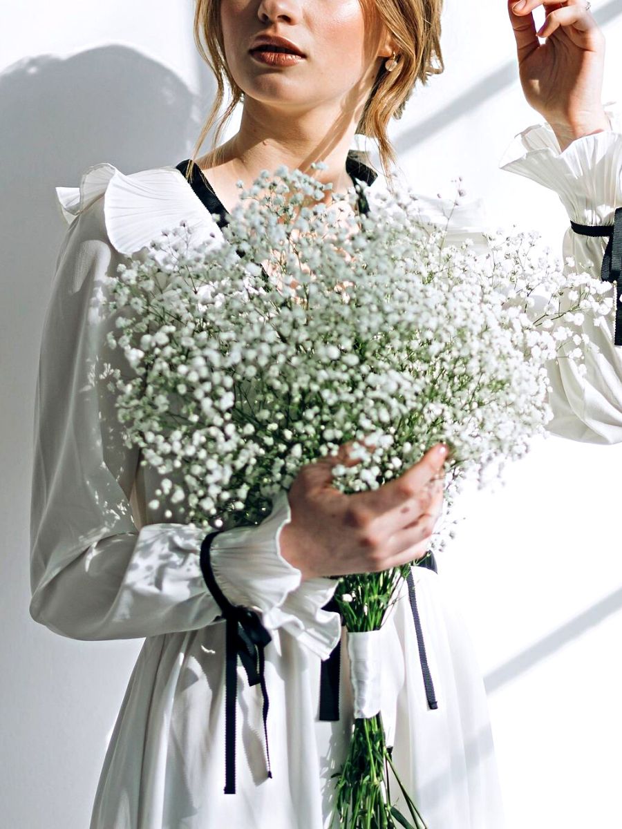 Girl holding a bouquet of babys breath