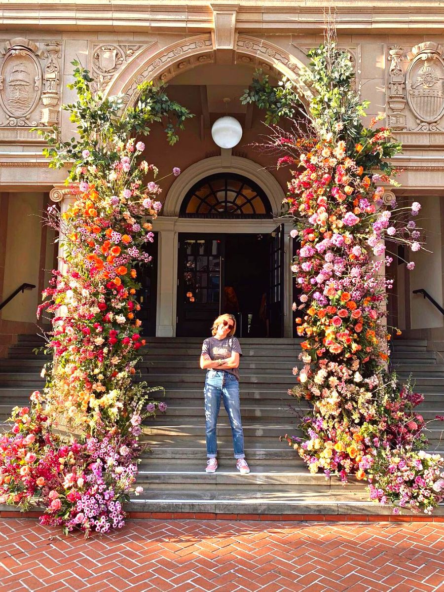 Natalie Gill alongside a floral decoration