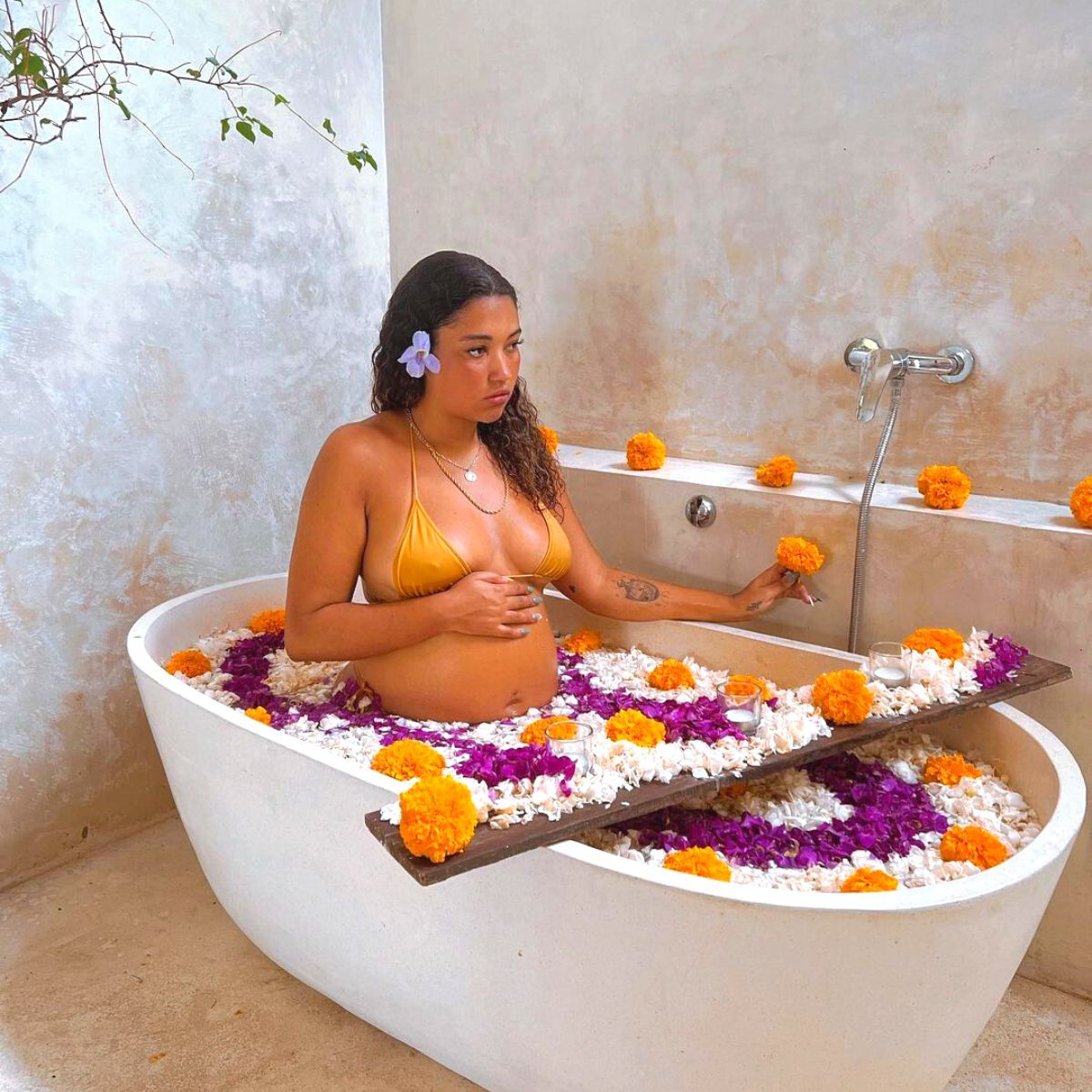 Pregnant woman taking a flower bath