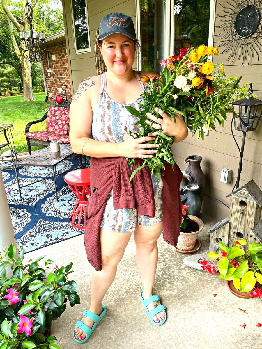 Happy girl creating her own floral arrangement