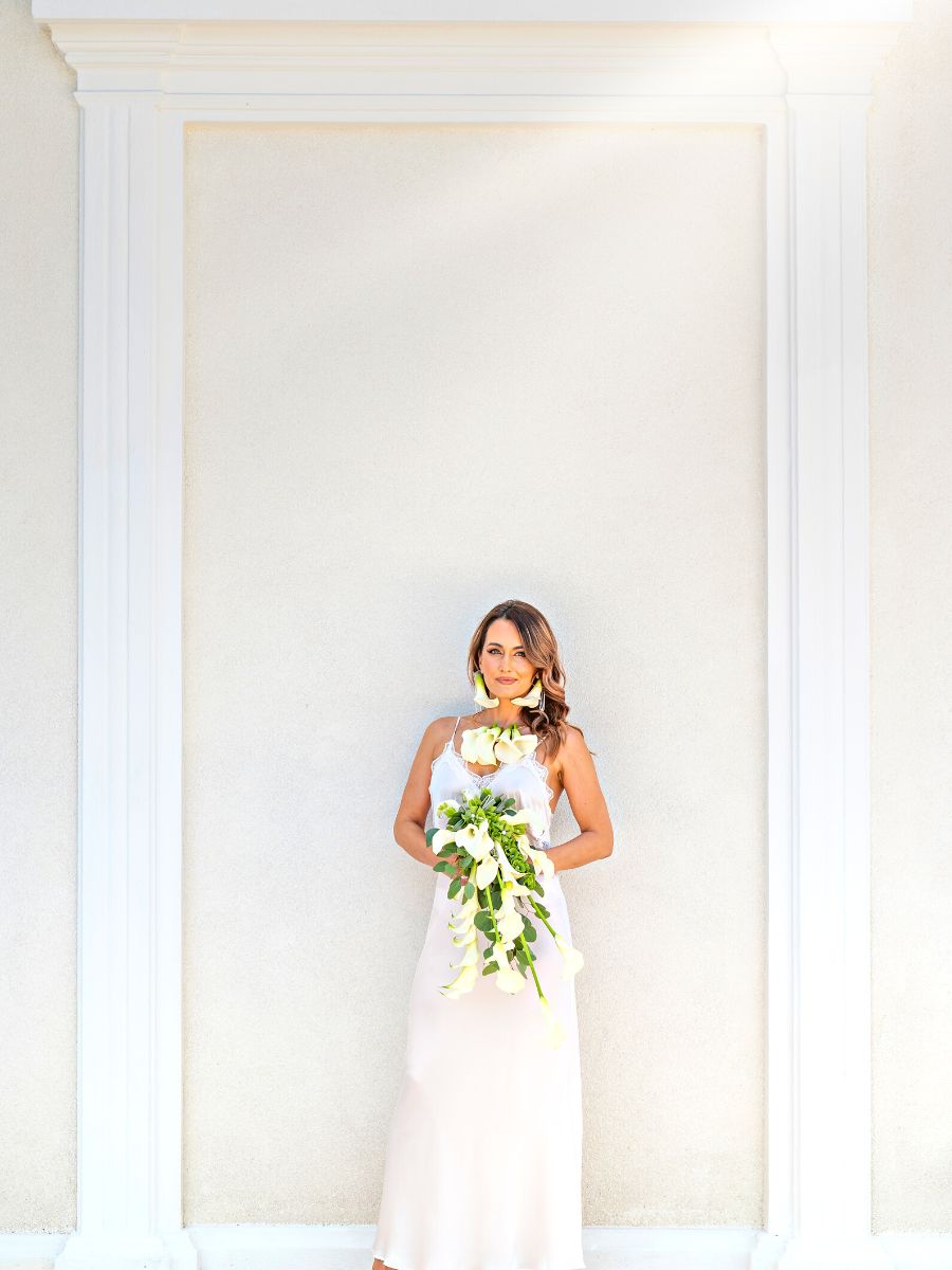 Far shot of the bride with calla bouquet