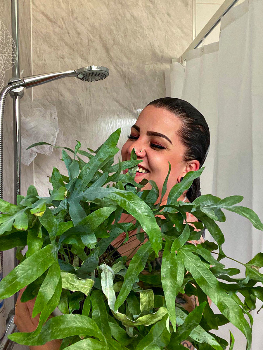Girl with plants in the shower 