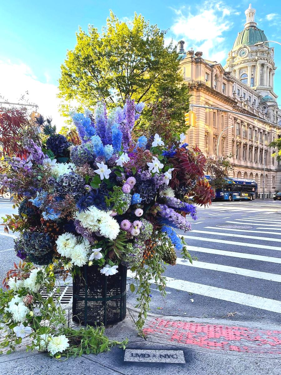 Blue combination flowers in trash can in NYC