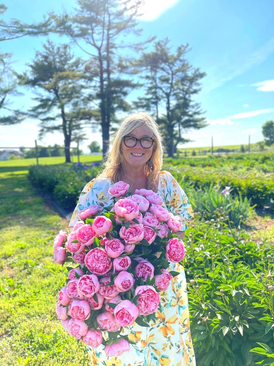 Holly Chapple arranging flowers in a garden