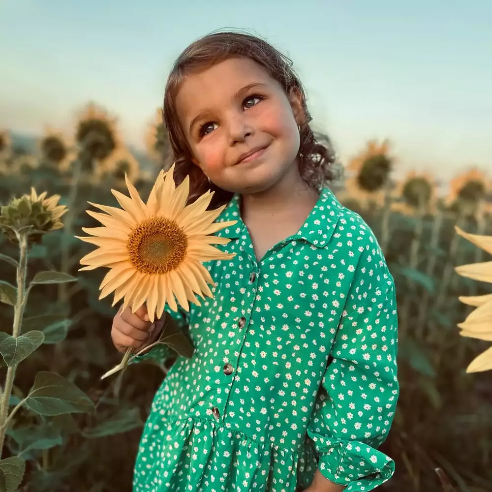 Cute baby with sunflower