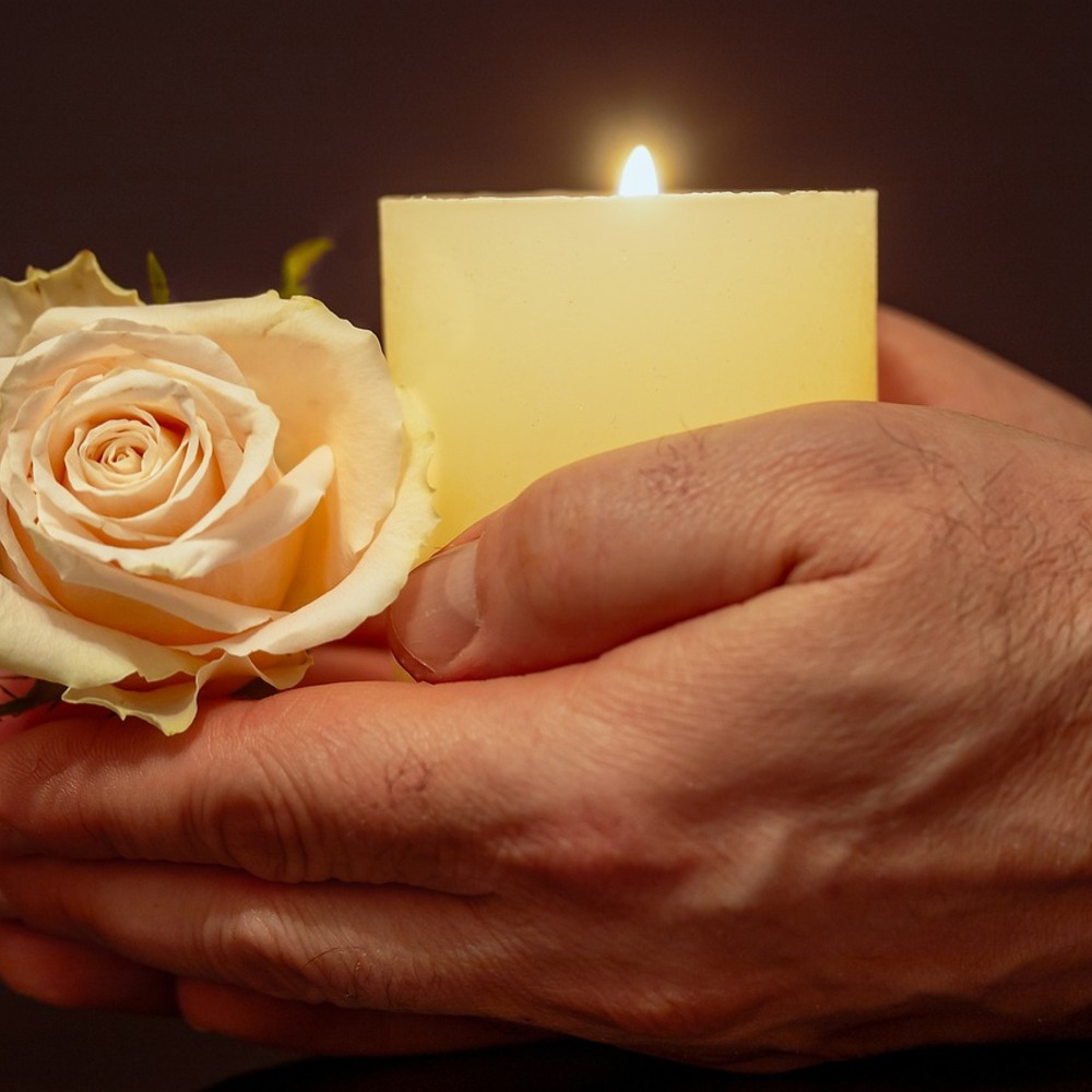 Candle with flower in hand
