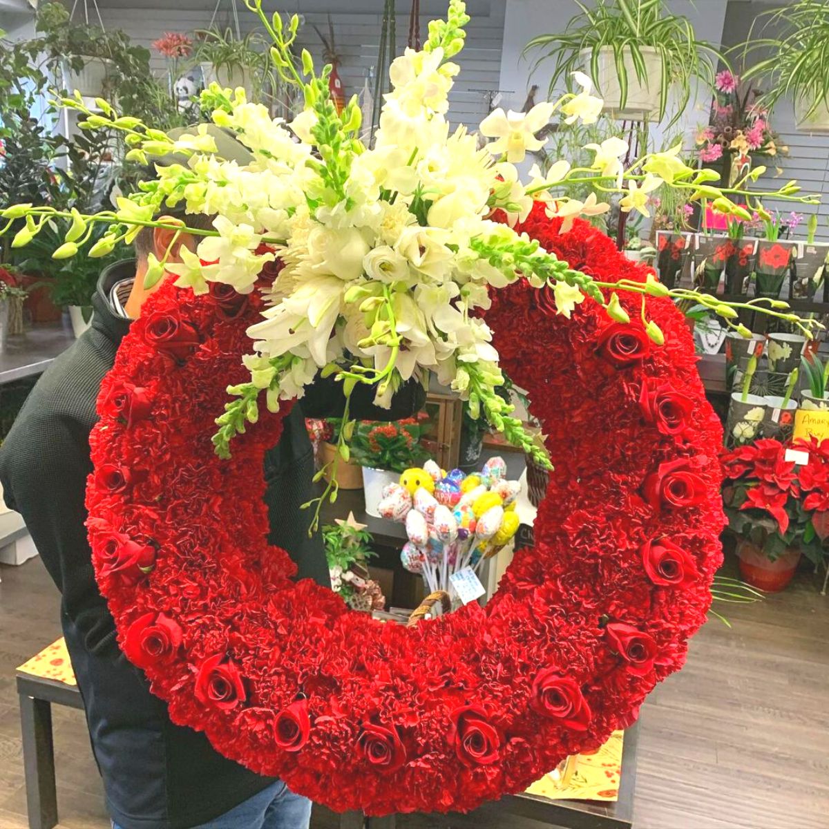 Giant wreath of red roses and carnations with white flowers