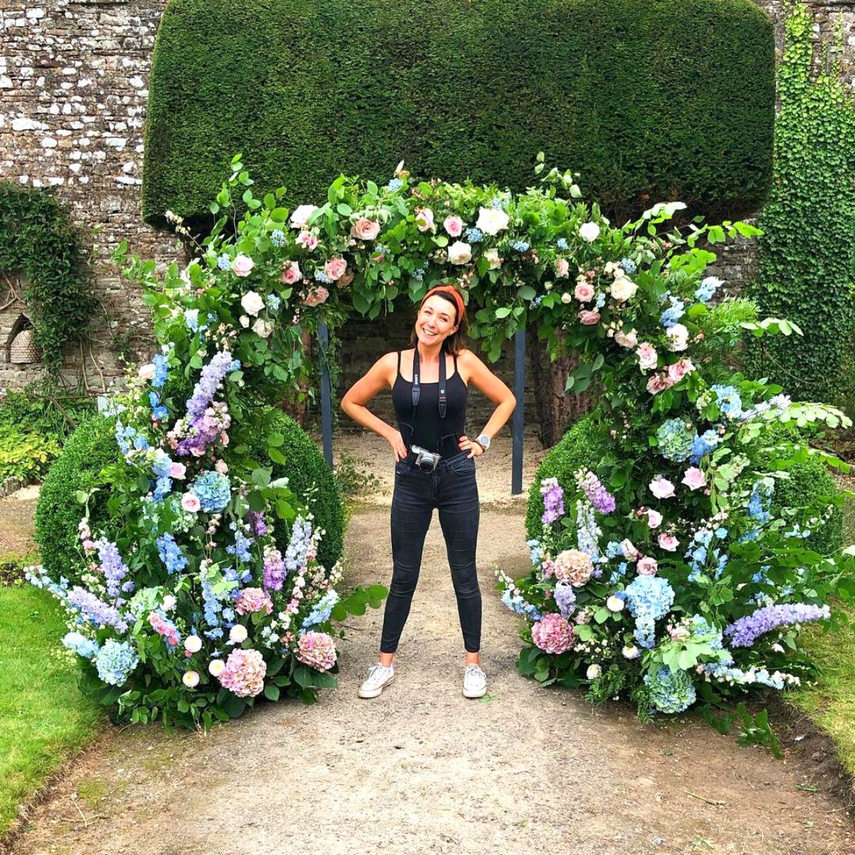 Rachel Husband in outdoor space with flowers