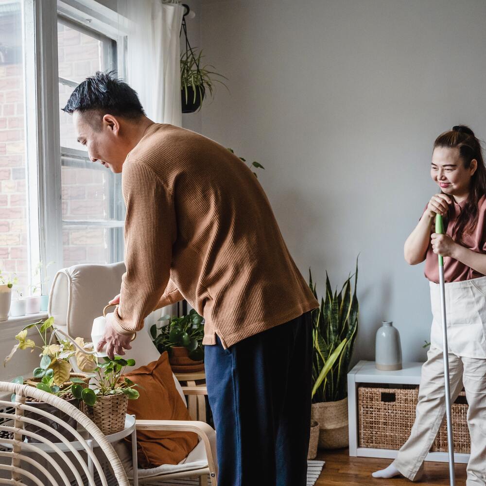 man caring inhouse plants