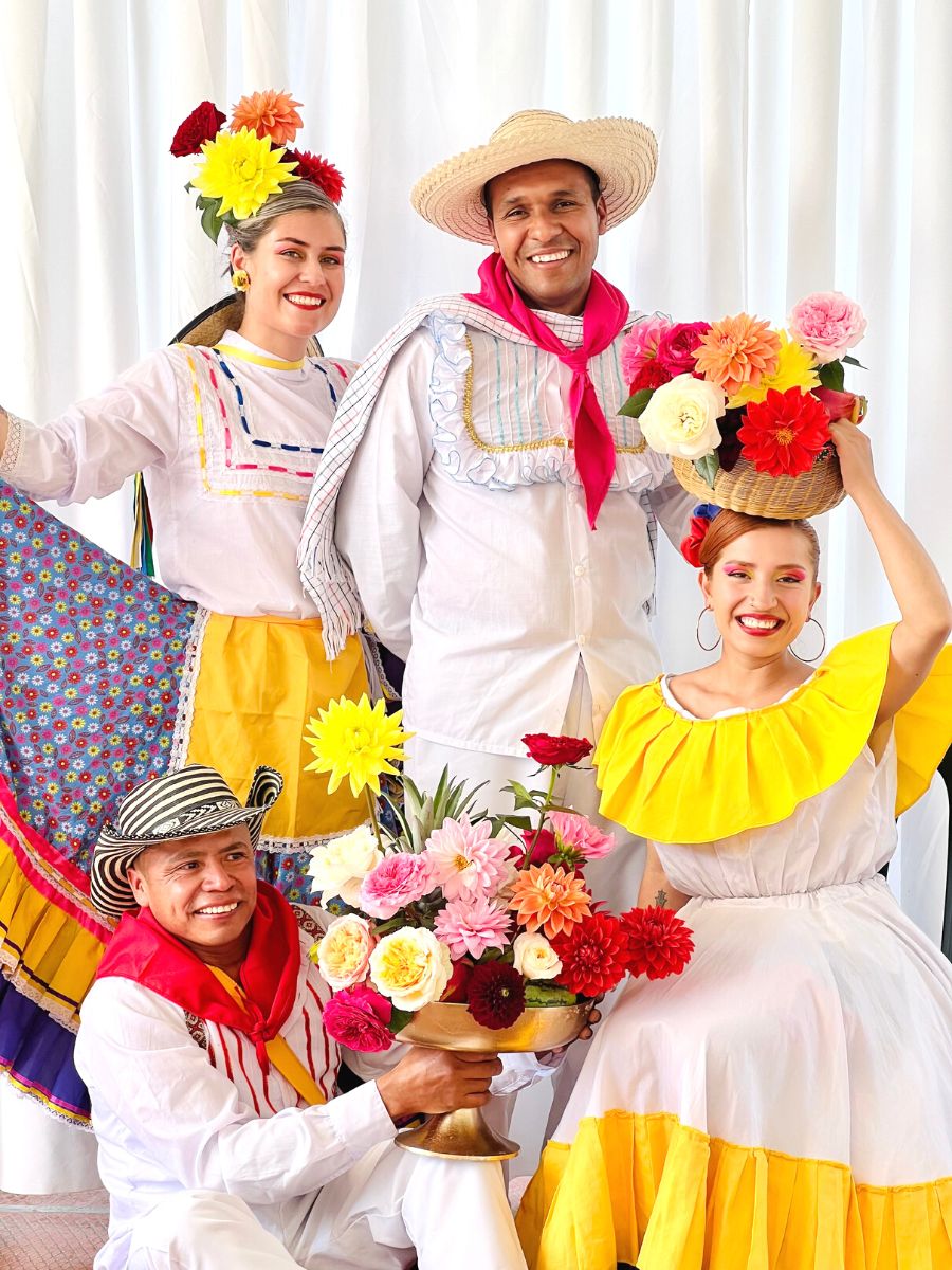 Colombian dancers with flower arrangements