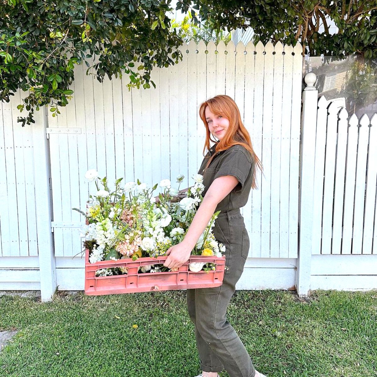 Maddy Walsh picking flowers from garden