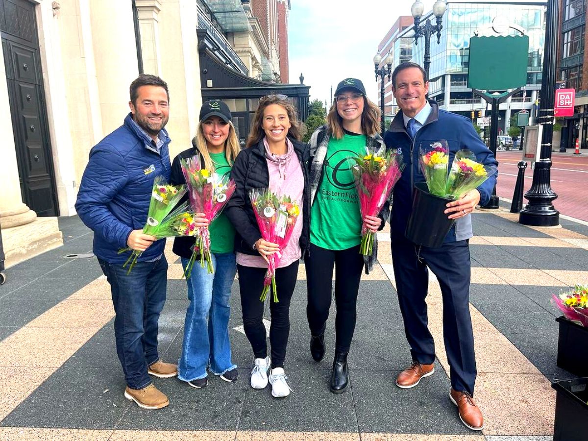 People receiving flowers in the street