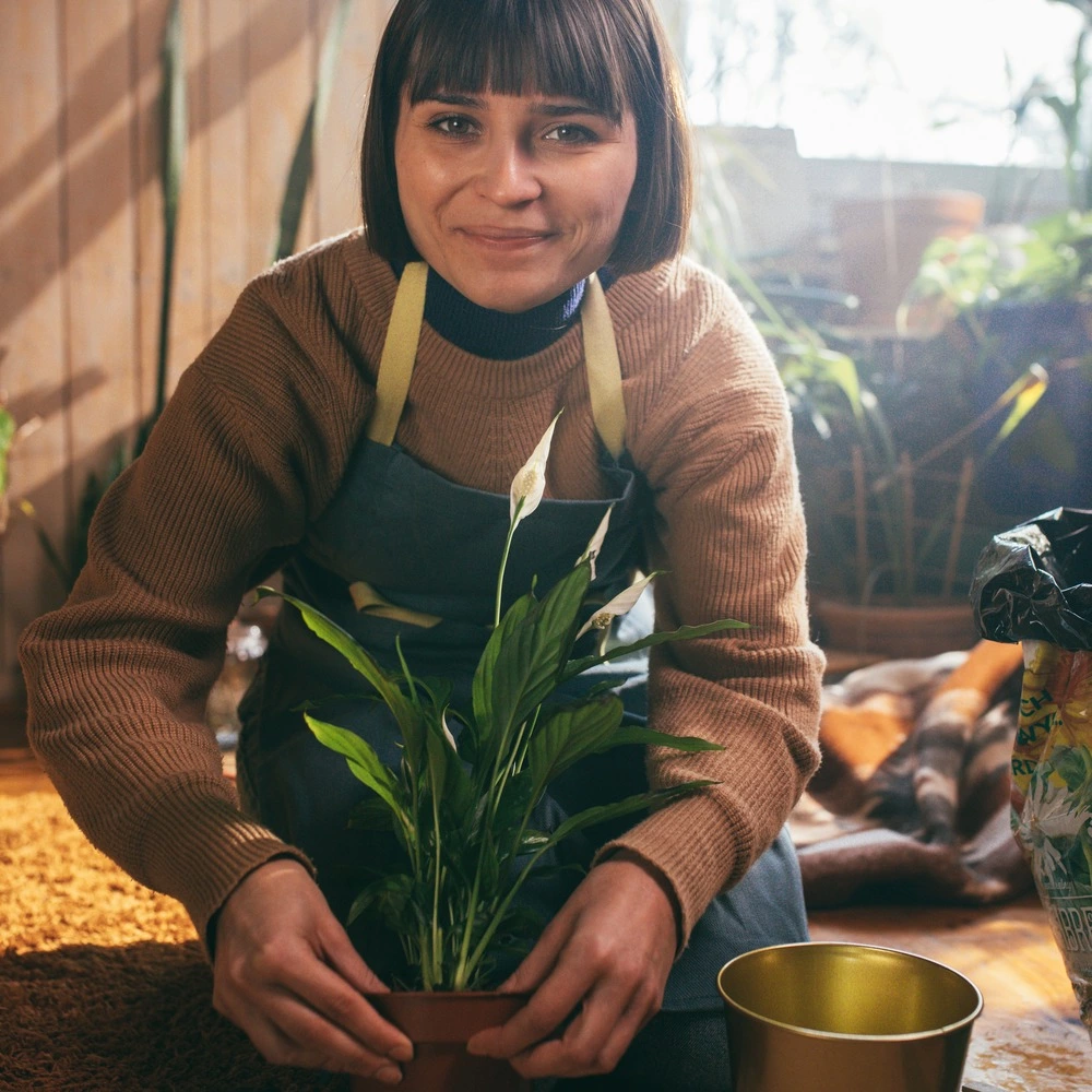 lady with Peace lily plant