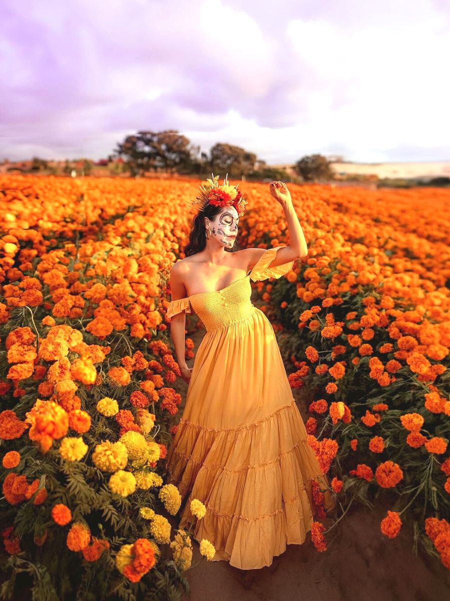 Catrina girl in the middle of a marigold field