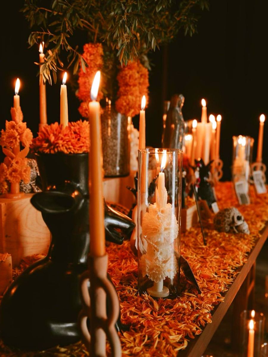 Ofrenda table with candles marigolds and skulls