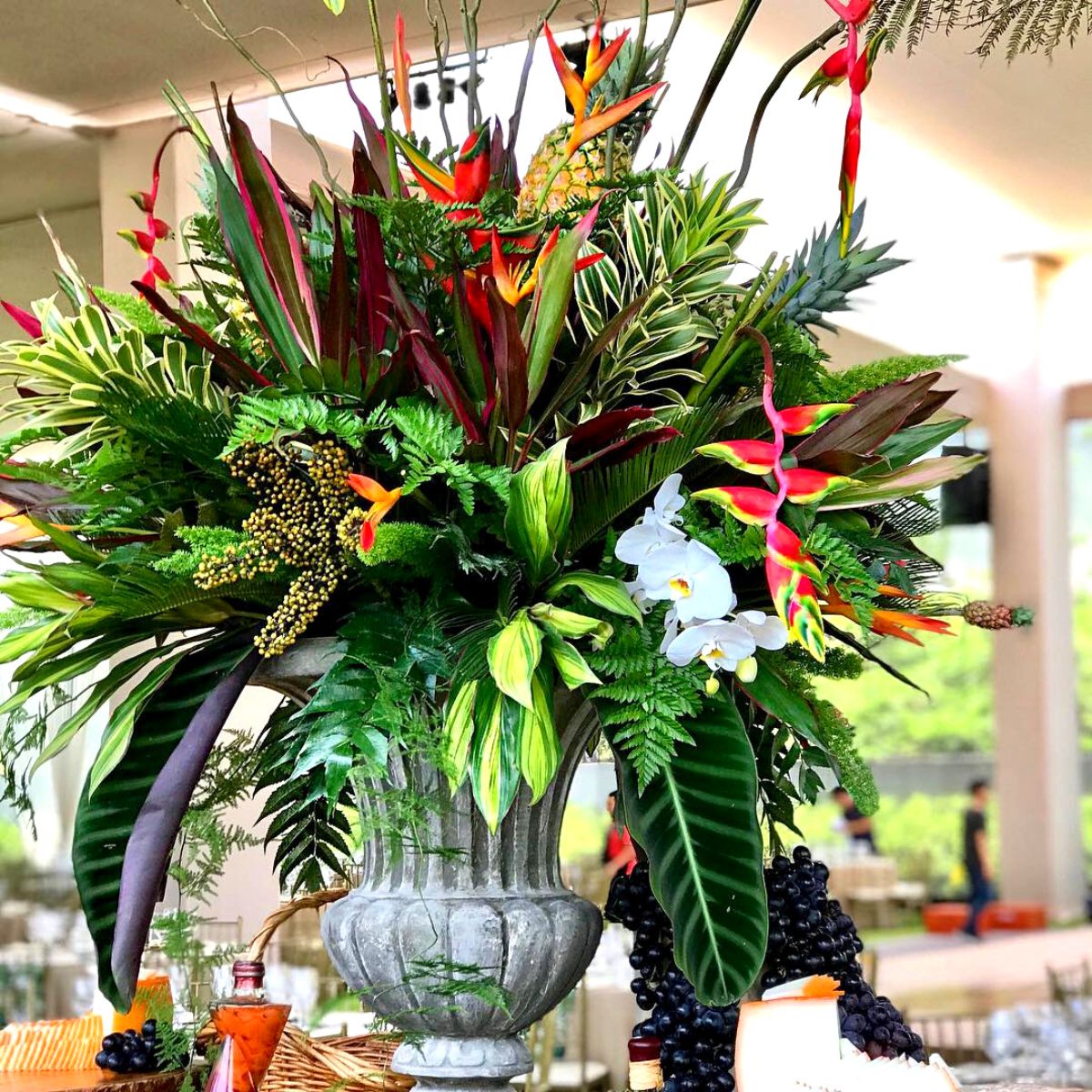 Tropical floral design with heliconia and orchids