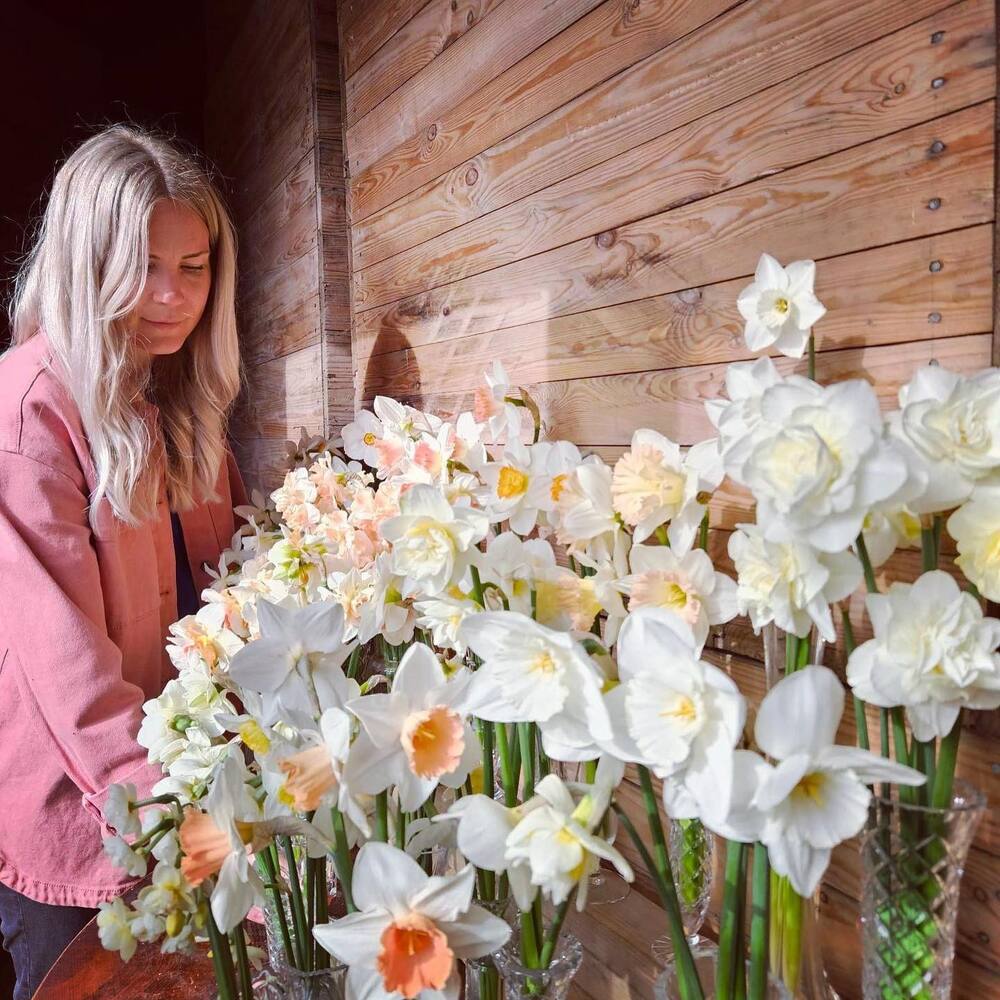 lady with white narcissus flower