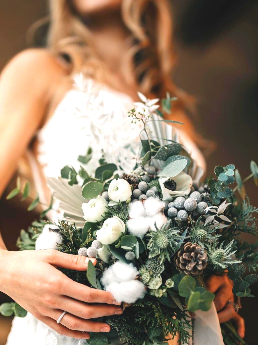 Christmas wedding bouquet with pinecones and greenery