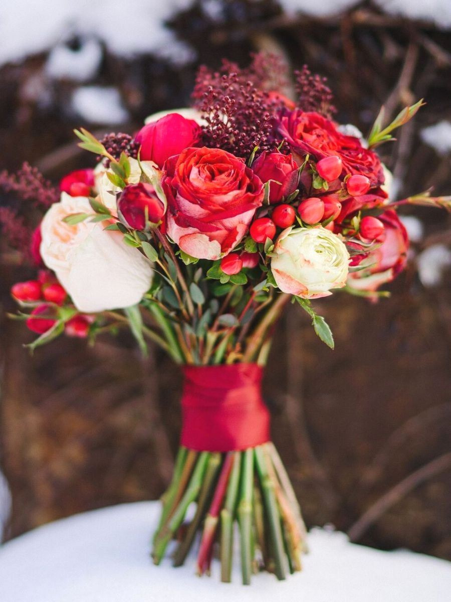 Red roses and rosehips for a Christmas wedding bouquet