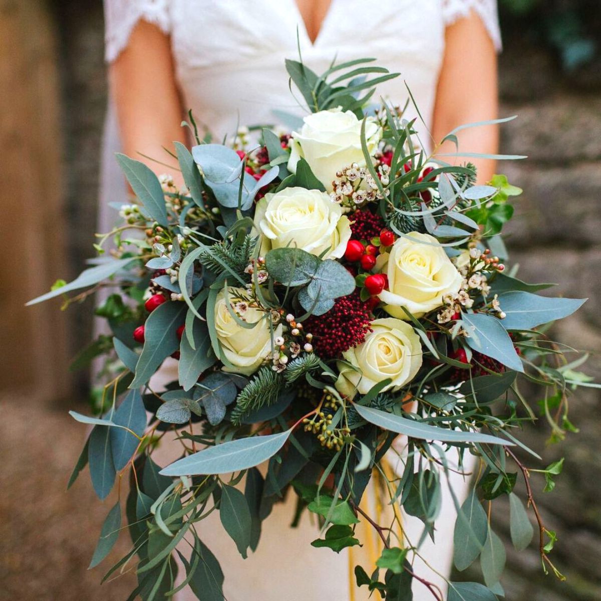 Classic combination of whites red and greens for wedding bouquet