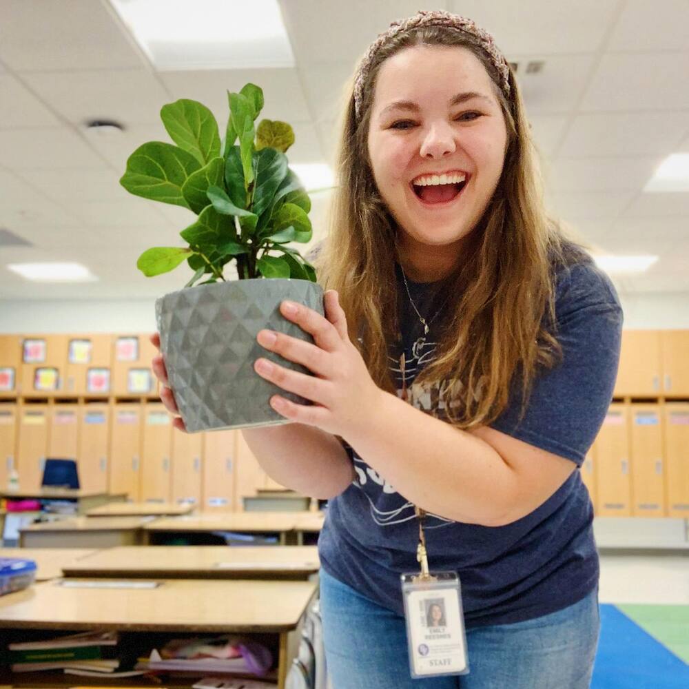Student with Calssroom plant