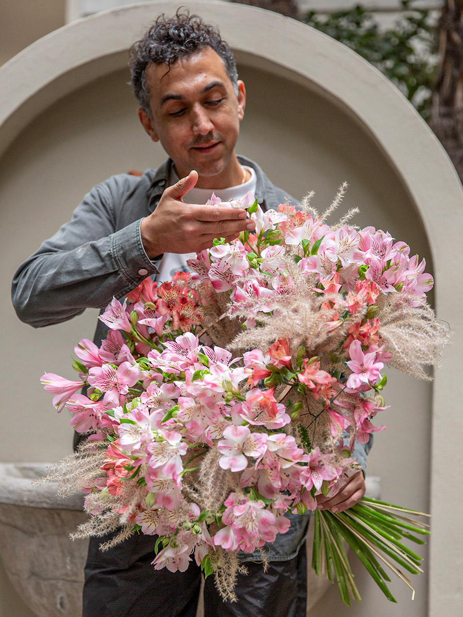 Dmitry Turcan holding an alstroemeria bouquet