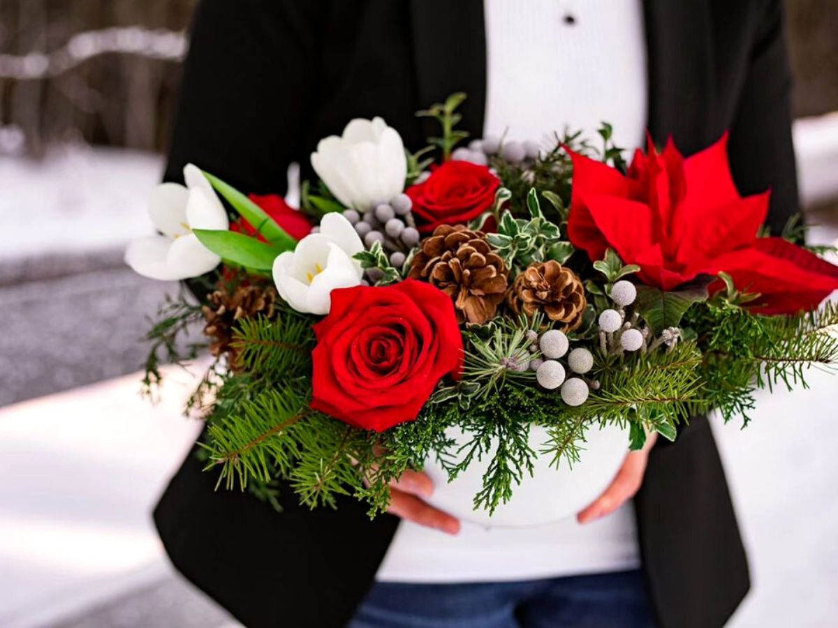 Red rose and red poinsettia Xmas floral design