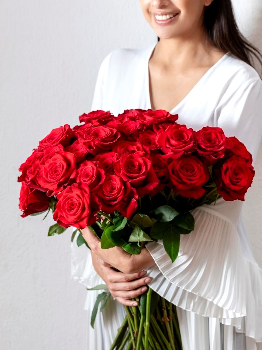 Smiling person with red roses for Valentines Day