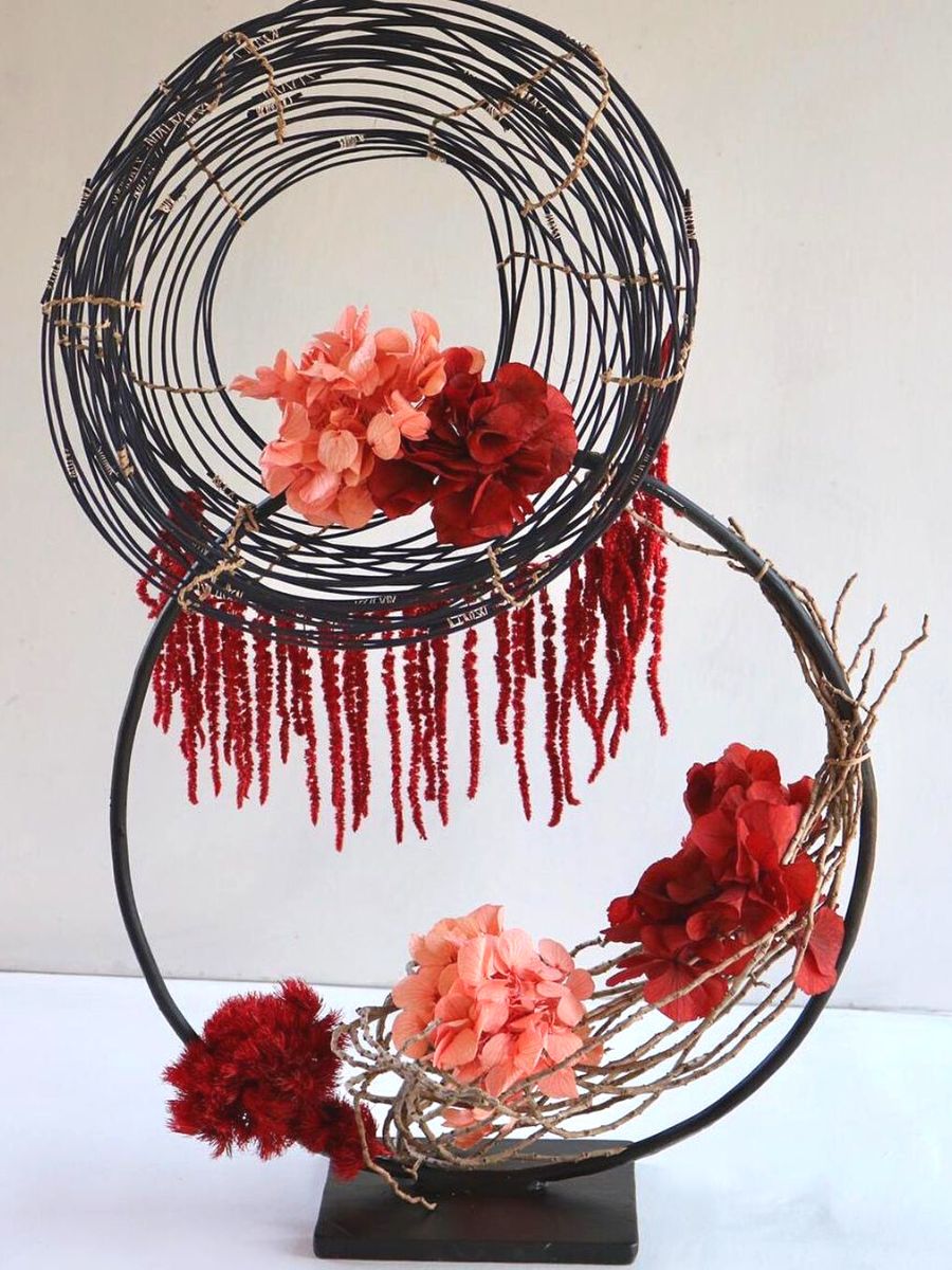 Floral art with red and salmon tones by Flowers Naturally