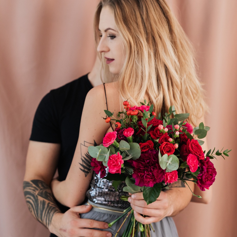 Couple pose with roses