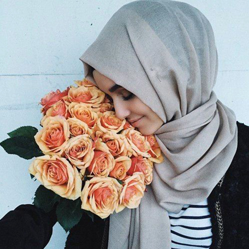 Muslim girl with orange rose