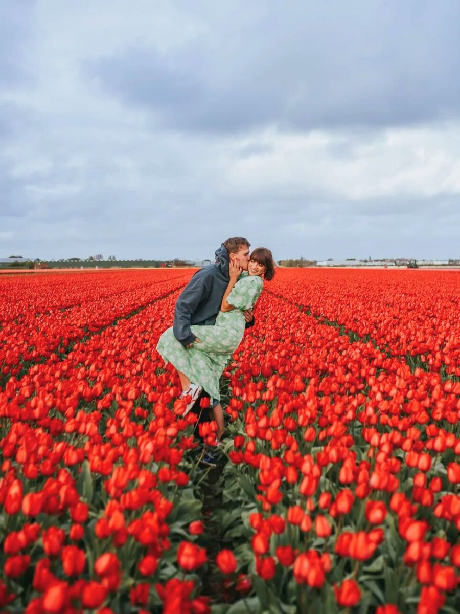 A couple having fun at the tulip fields in Holland