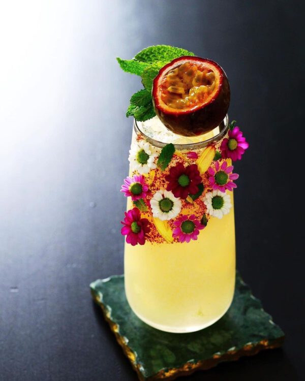 Floral Cocktails That Are a True Work of Art - Veermaster Berlin - via Weddingforward - yellow tropical cocktail with flowers in tumbler on thursd