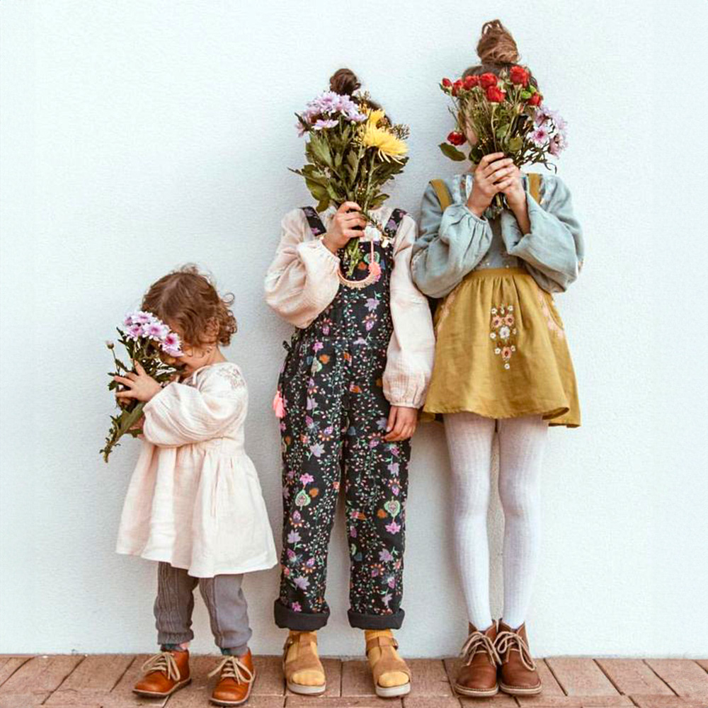 Three children with chrysanths and roses for Mother