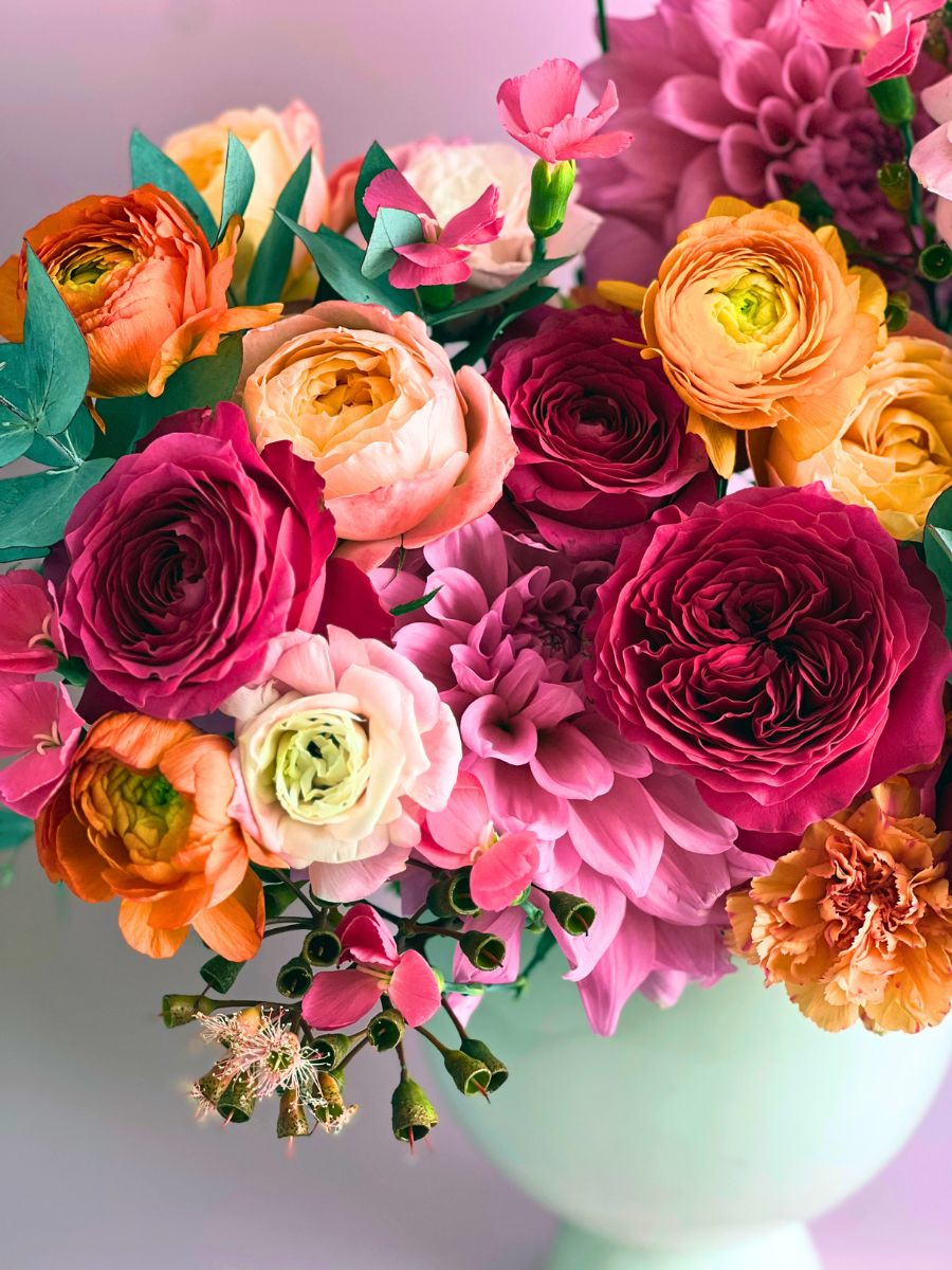 Boldly colored arrangement using garden roses by Alexandra Farms